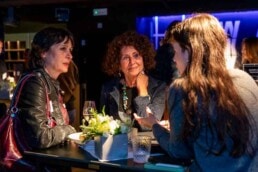 Three women speaking and having a conversation during the NYC Tourism Convention in Brussels
