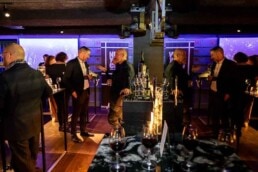 A view of a room where half the frame is the room and the other half is the reflection of the same room through a mirror during the NYC Tourism Convention in Brussels