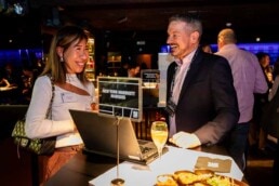A woman on the left and a man on the right having a conversation during the NYC Tourism Convention in Brussels