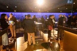 A room full of people engaging with each other on a networking moment during the NYC Tourism Convention in Brussels