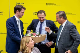 Christophe Hansen, European Commissioner for Agriculture and Food, receiving a gift box by Peter Hauk at a conference in Brussels 2025
