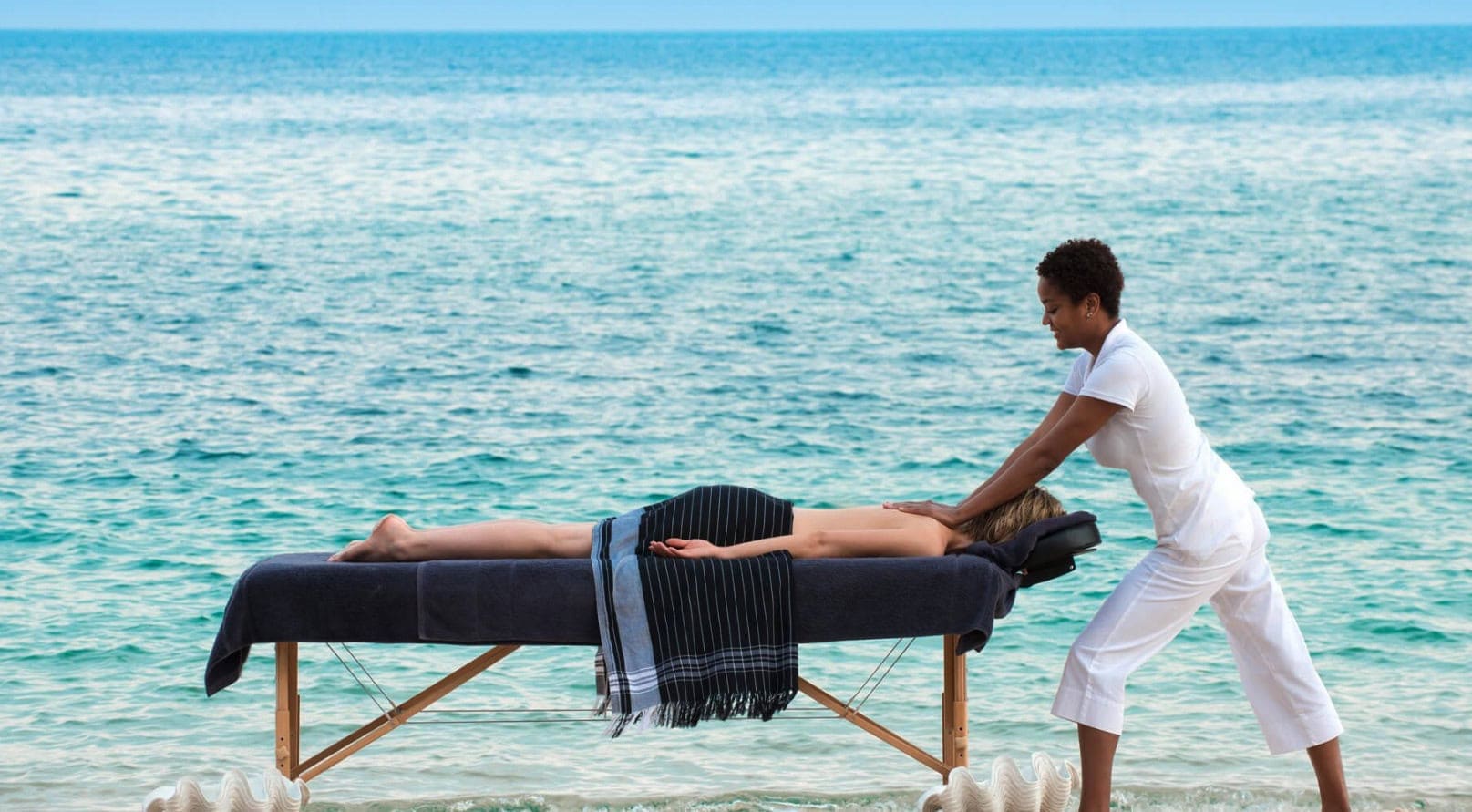 View of a woman getting a massage along the coast of a resort in Mozambique