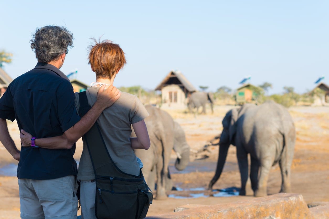 Couple observing an elephant on their honeymoon safari in Botswana.
