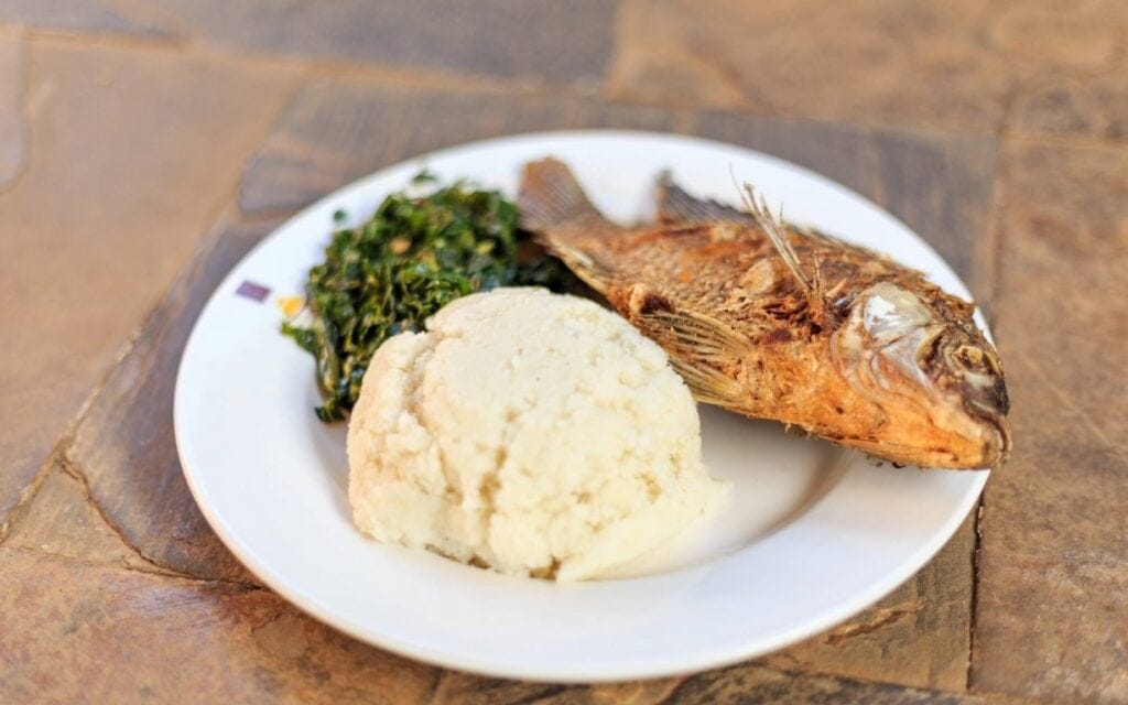 Ugali, fish and greens | Photo: Jacek_Sopotnicki via Getty