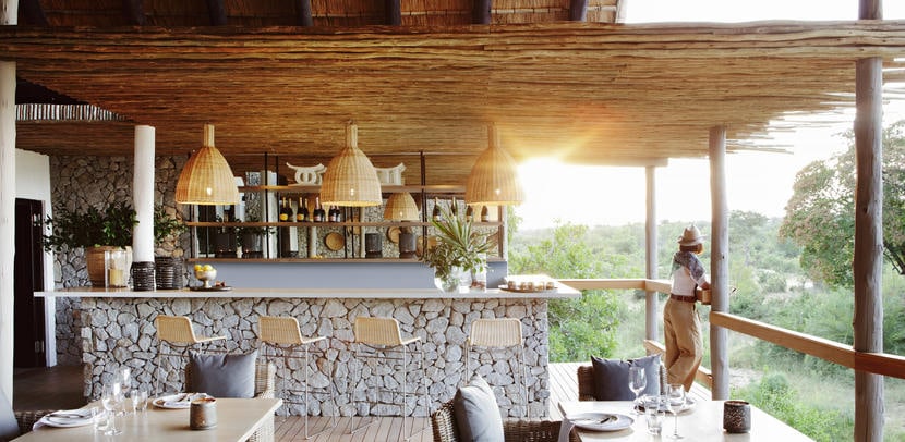 A bar overlooking the wilderness in Greater Kruger at Londolozi Private Granite Suites, a luxury safari lodge.