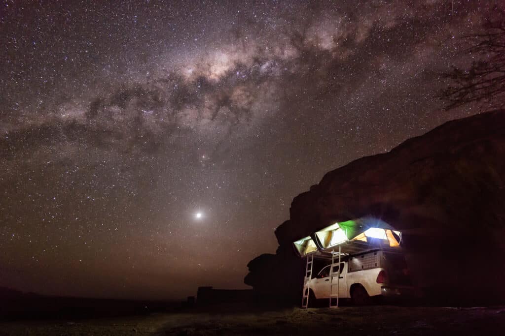 Sleeping in roof tent outside in desert Namibia, Africa