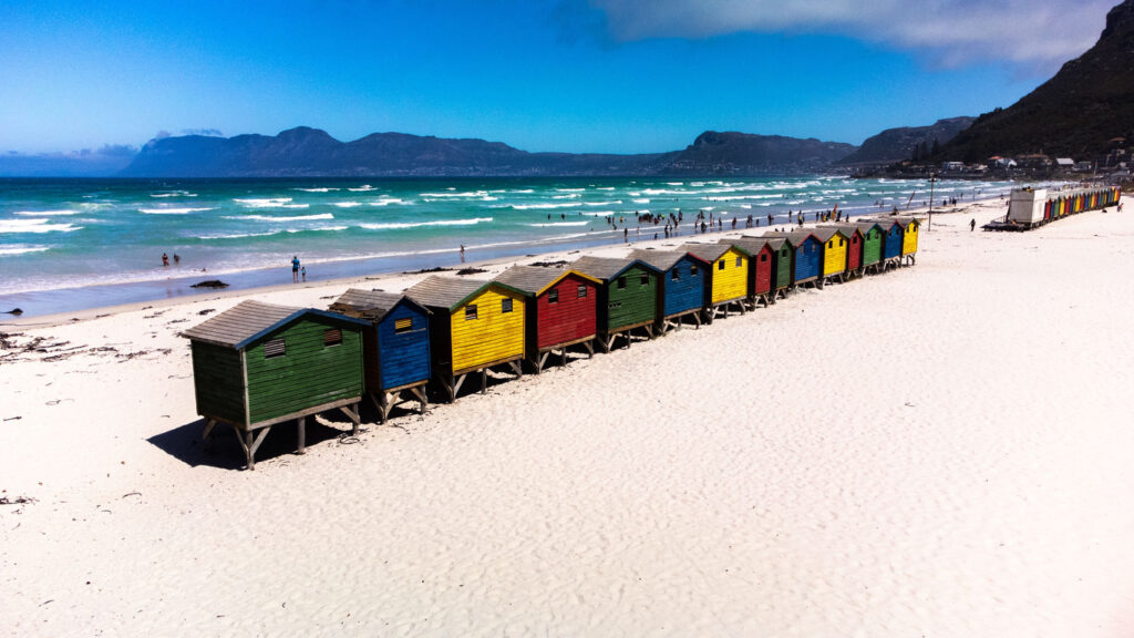 A row of colorful beach houses in Muizenberg Beach, Cape Town.