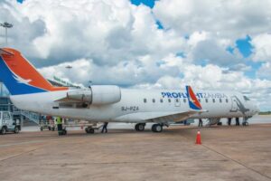 Plane on the ground with cloudy sky