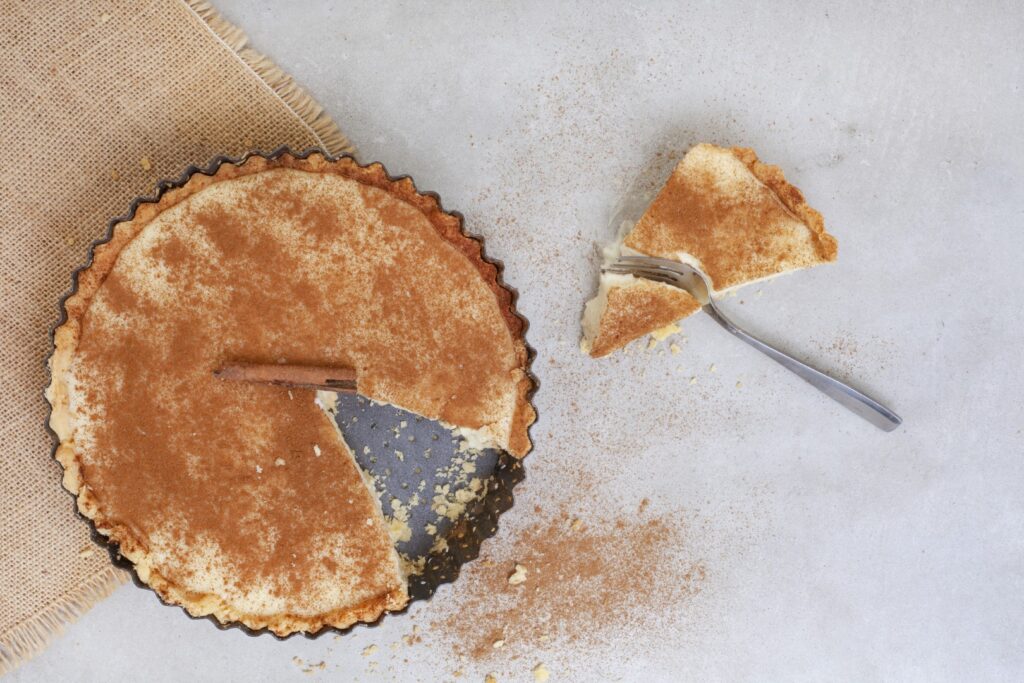 Traditional South African milk tart freshly baked and in tin, a popular South African Food. Photo: Getty Images