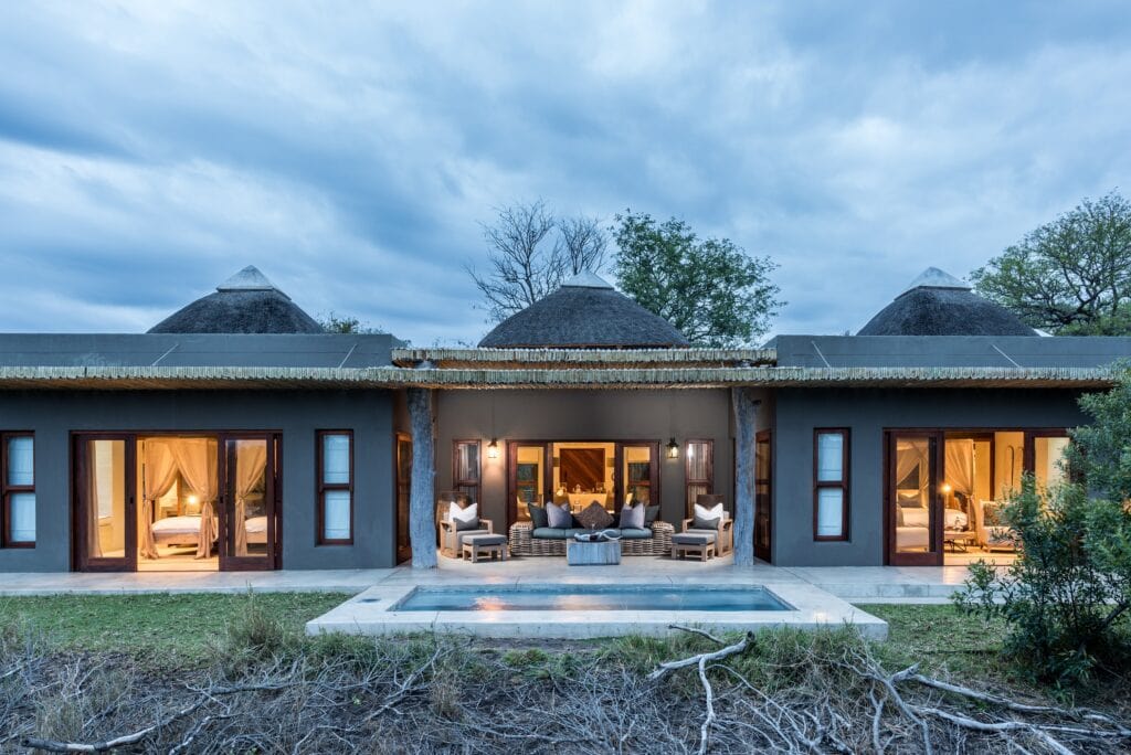 Single story safari villa with pool in front. 