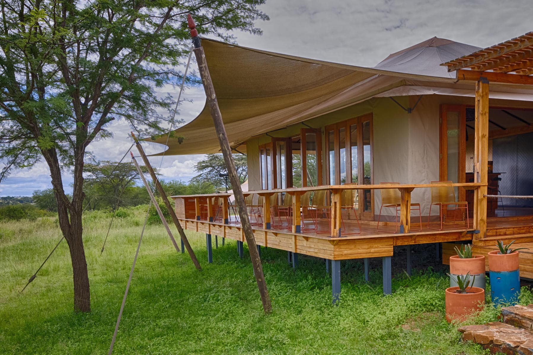 Deck leading from the bar area at Asilia Africa Sayari, a luxury safari lodge.