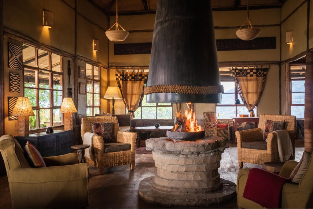 Fireplace in the centre of the room with armchairs all around