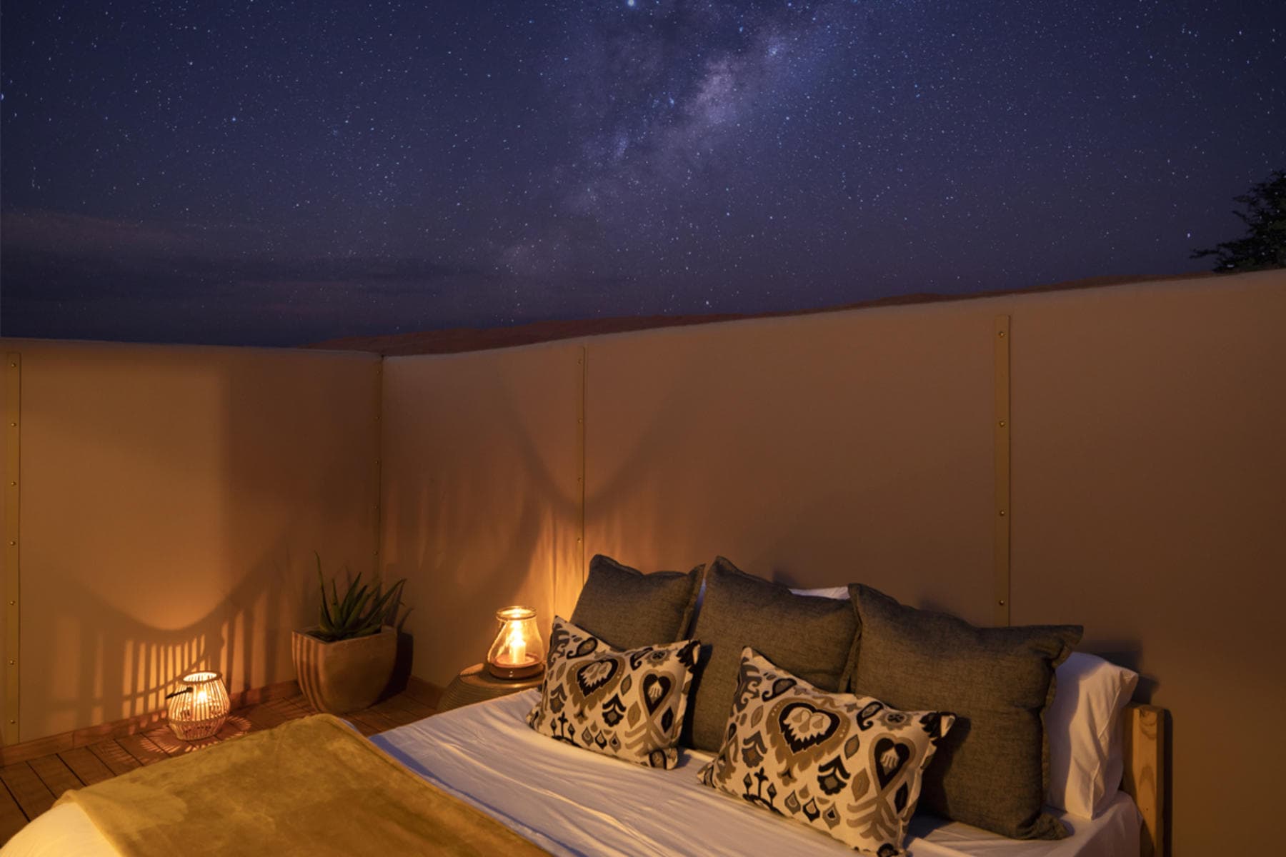 Star beds under the night sky at Kwessi Dunes, a luxury safari lodge. 