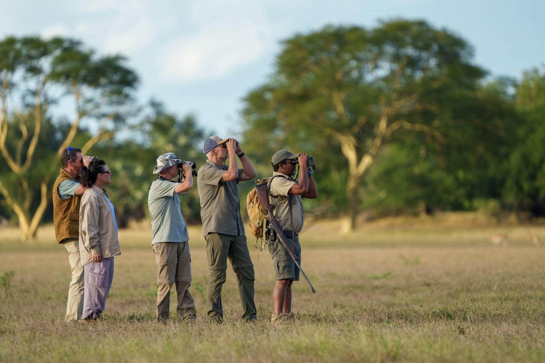 Safari-goers on a walking safari in the bush