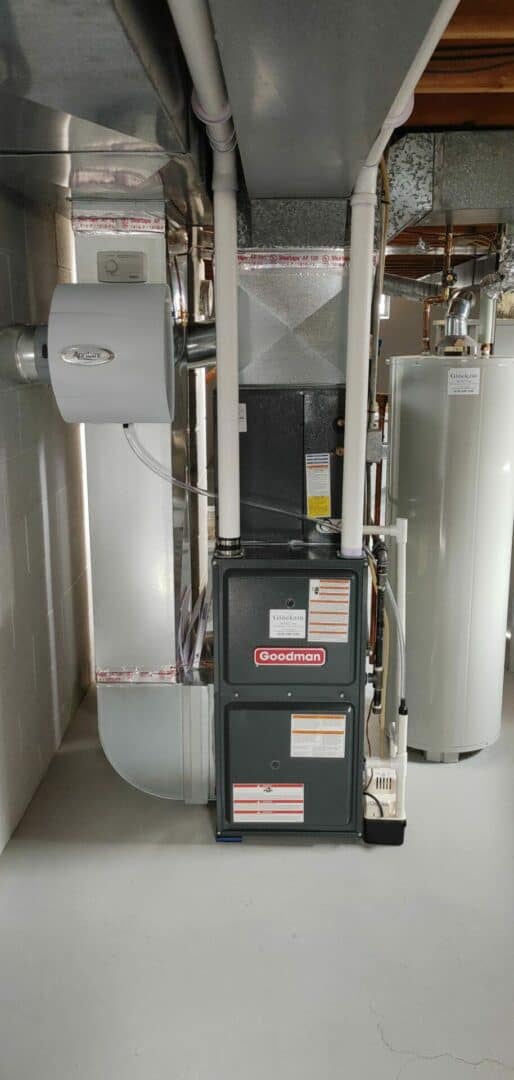 Indoor HVAC furnace system with ductwork and Goodman furnace unit.