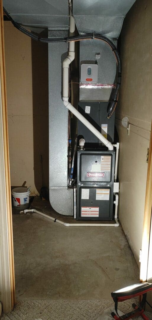 HVAC furnace and duct system in a utility closet.
