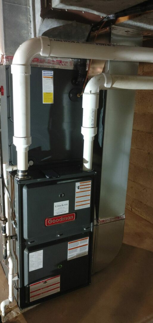 HVAC furnace with ductwork in a basement setting.