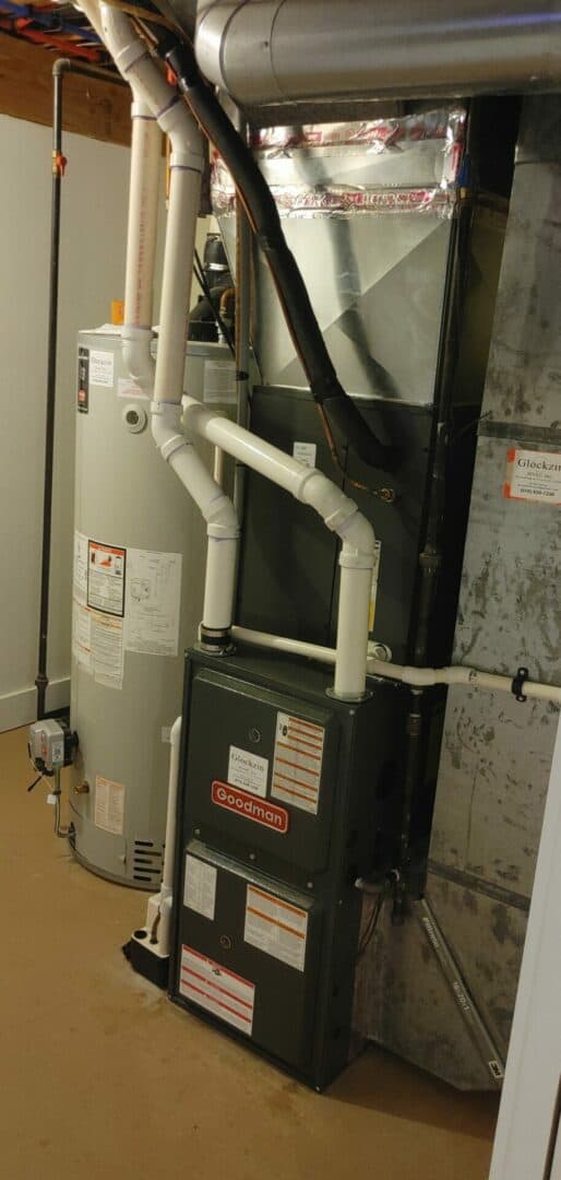 Indoor HVAC unit with pipes and ductwork in a residential setting.