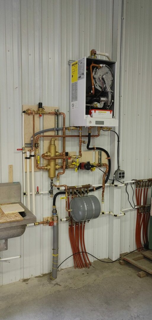 HVAC boiler system with copper piping and control unit mounted on wall.