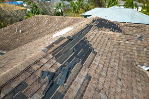 a roof damaged by strong storm winds