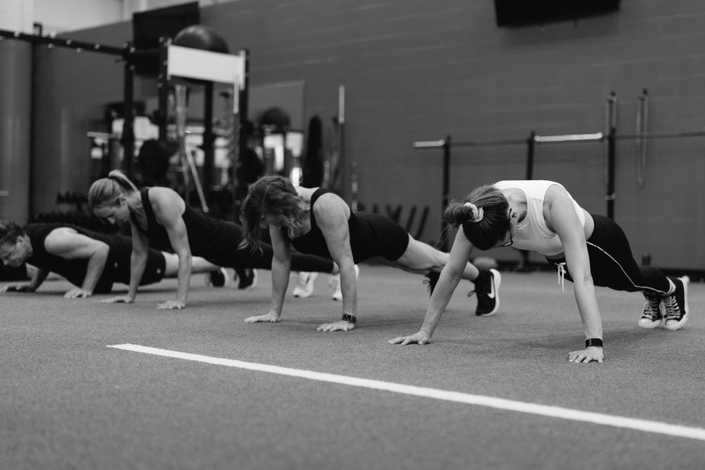 Women doing push-ups during a Pilates class at Grit Pilates and Yoga.