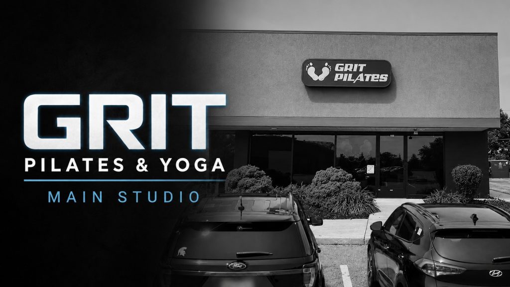 Exterior view of Grit Pilates and Yoga studio with parking lot.