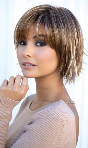 Stylish short layered wig with highlights on a woman with short hair.