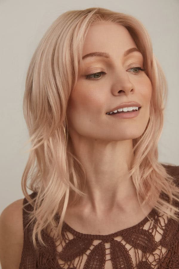 Blonde wavy bob wig worn by a woman with light makeup and a lace top.