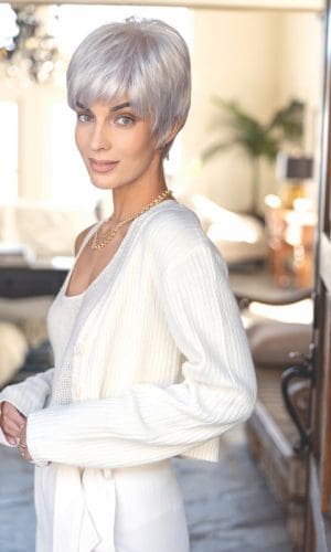 Woman with short silver wig, stylish and modern, in a cozy home setting.