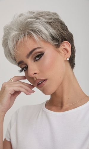 Stylish short gray wig on a woman with makeup and jewelry.