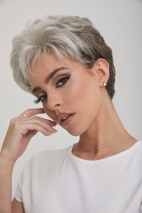 Stylish short gray wig on a woman with makeup and jewelry.