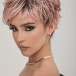 Short pink curly wig with layered texture and volume for stylish looks.