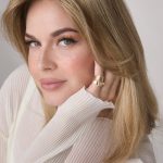 Beautiful blonde woman with styled hair and natural makeup.