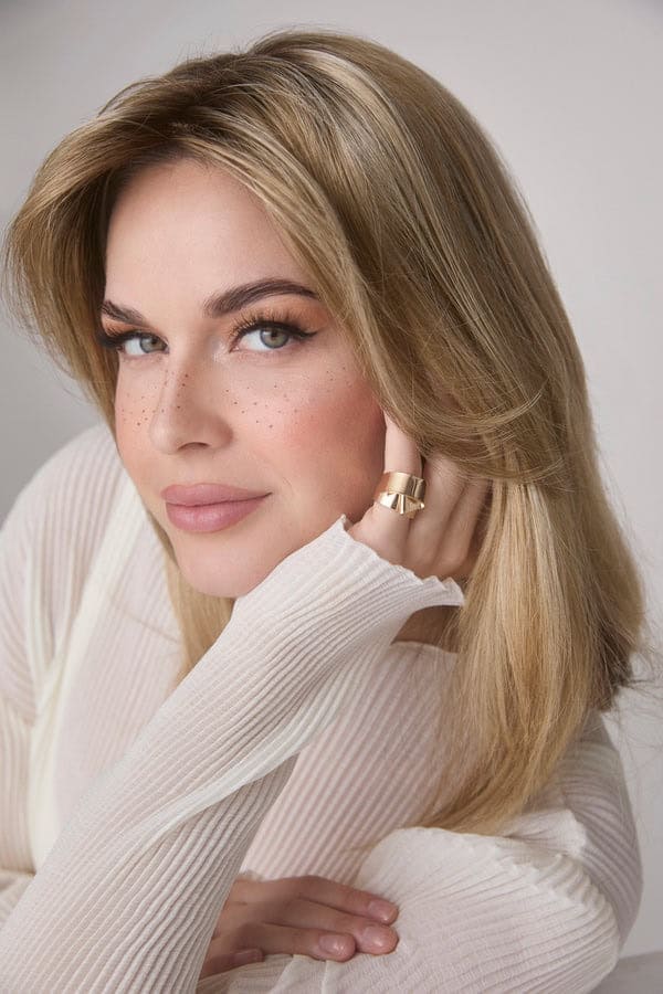 Beautiful blonde woman with styled hair and natural makeup.