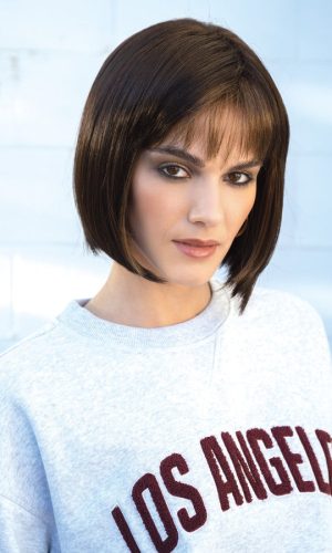 Woman with short brown bob wig and bangs, wearing a gray Los Angeles sweatshirt.