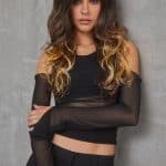 Woman with long wavy ombre hair in black and blonde shades.
