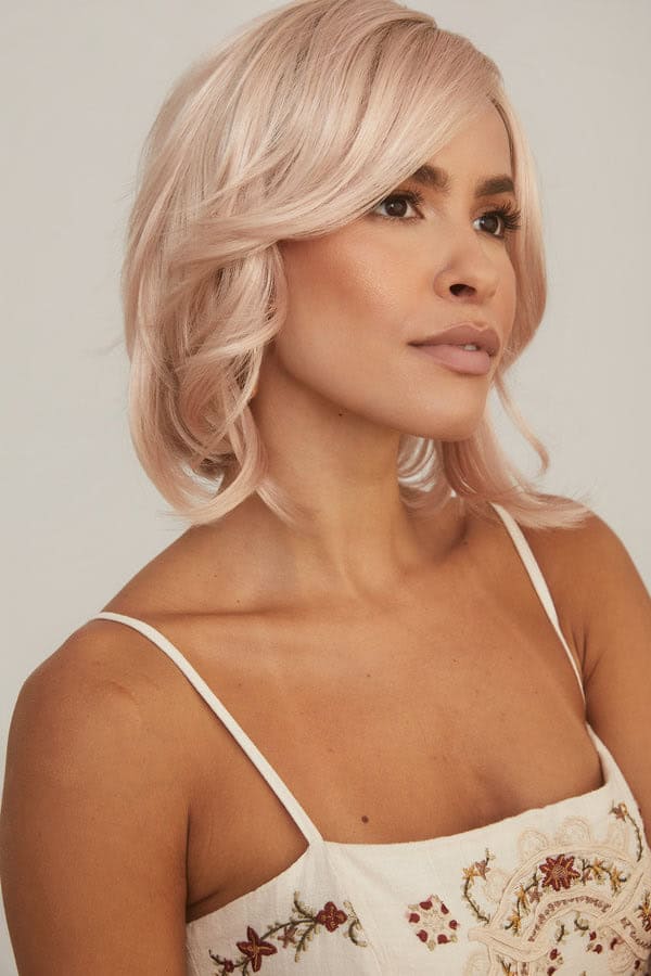 Blonde wavy bob wig worn by a woman with light skin and minimal makeup.