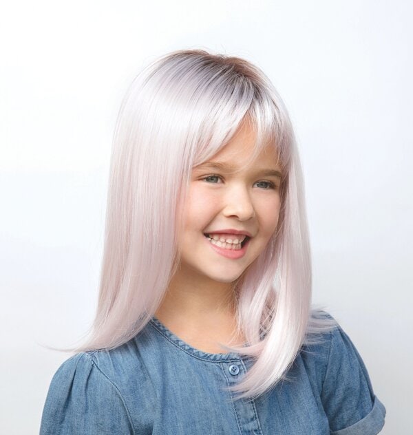 Young girl with long, straight, platinum blonde wig smiling.