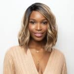 Beautiful woman wearing a blonde, wavy lace front wig from Hidden Secrets Wigs.