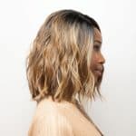 Wavy blonde wig with dark roots from Hidden Secrets Wigs.