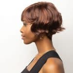 Short, layered auburn wig with soft waves for a natural look.