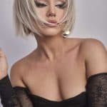 Stylish blonde bob wig with layered cut and side-swept bangs.