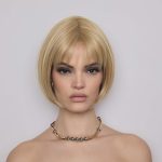Blonde bob wig with side-swept bangs for a stylish look.