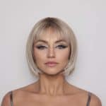 Blonde bob wig with side-swept bangs, perfect for elegant looks.