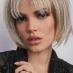 Blonde bob wig with layered bangs, styled for a modern look.