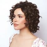 Curly short bob wig from Hidden Secrets Wigs, styled on a woman with natural makeup.