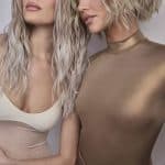 Two women with stylish, wavy blonde wigs from Hidden Secrets Wigs.