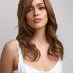 Stylish brunette wig from Hidden Secrets Wigs, model with soft waves and natural look.