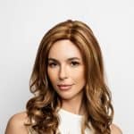 Beautiful woman with long, wavy, light brown wig from Hidden Secrets Wigs.