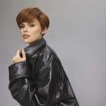 Stylish woman with short brown hair wearing a black leather jacket.